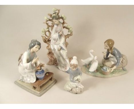 LLADRO.
Four various Lladro figures, including two oriental ladies & a goose girl.