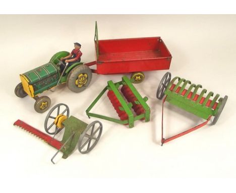 TIN PLATE TOYS.
A Mettoy tin plate farm tractor with driver & four various attachments.