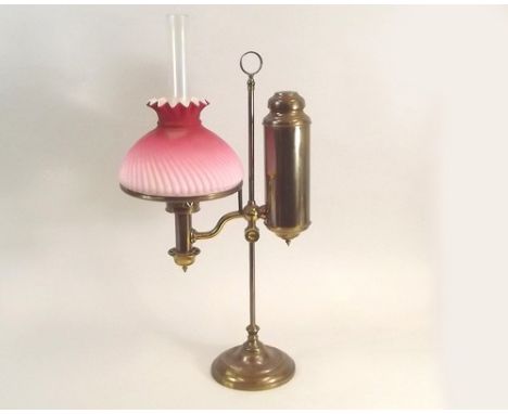 STUDENT'S OIL LAMP.
A student's brass, rise & fall oil lamp, with pink & white cased shade. Full height 56cm.