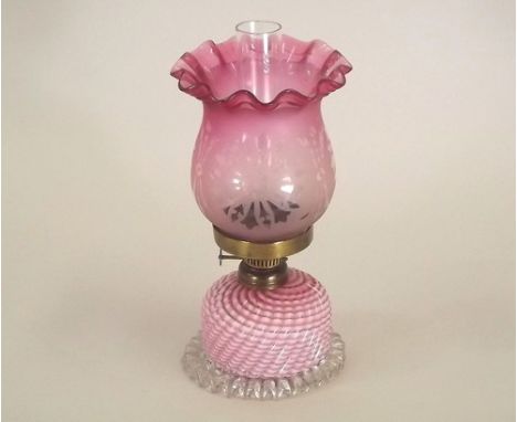 OIL LAMP.
A Victorian small oil lamp with cranberry glass shade. 23cm.
