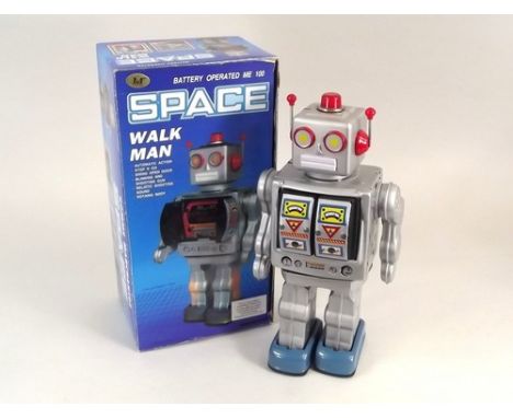 ROBOT.
A boxed, tin-plate & plastic, battery operated 'Space Walk Man' robot with rotating body & opening chest shooting gun 