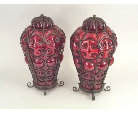 LAMPSHADES.
A pair of blown ruby glass, metal mounted lampshades. Height 38cm.