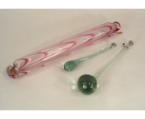 VICTORIAN GLASS.
A Victorian Nailsea-type glass rolling pin, 47cm & two glass novelties, longest 32cm. 