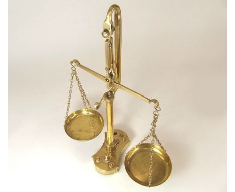 BRASS SCALES.
A set of brass beam scales, with seven (of eight) weights to the shaped base.