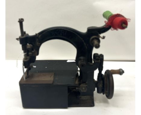 A 19th century table top sewing machine, 30 cm wide Provenance:&nbsp; A single owner collection, from the studio of a seamstr