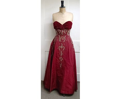 A vintage female mannequin, on a metal tripod base, 170 cm high, and a red evening dress Provenance:&nbsp; A single owner col