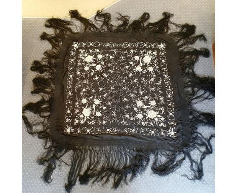 A 1920s white and black silk embroidered shawl, decorated flowers