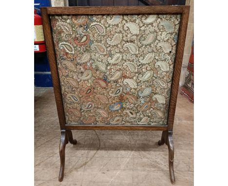 An Indian embroidered panel, decorated stylised boteh forms, inset into a firescreen, 80 x 59 cm