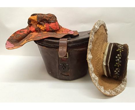 A leather hatbox, an embroidered hat cover, decorated flowers, and assorted hats including a Jean-Charles Brosseau (3) Proven