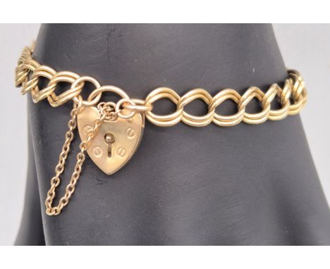 Vintage 9ct yellow gold gate bracelet fitted with a heart lock. 10.20grams. 