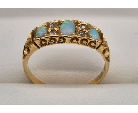 Antique 18ct yellow gold, opal and diamond stone ring. Three oval cut opals and four round cut diamonds. 4grams. Ring size Q.