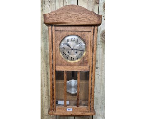 Vintage oak cased art Deco wall clock. 77cm tall. Comes with key and pendulum. 