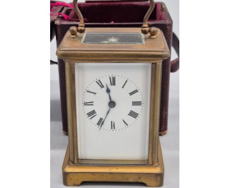 19th century brass and bevel glass carriage clock. White dial and Roman Numerals. Comes with a key and is in a working condit