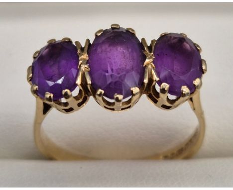 9ct yellow gold ladies ring fitted with three large oval cut Amethyst gem stones. 3.38grams. Ring size R. 