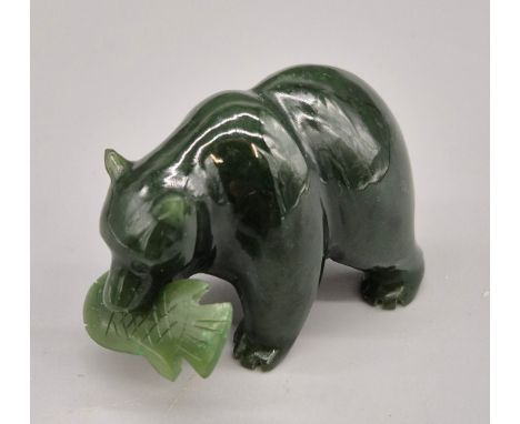 Hand carved Jade sculpture of a bear holding a fish within its mouth. 4.5cm length. 