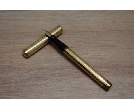 A Mabie Todd Self Filling lever fill fountain pen in yellow metal in engine turned chequered design with clipless cap having 