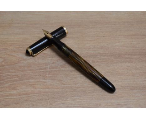 A Pelikan 400NN piston fill fountain pen in tortoise shell brown striped with black cap having Pelikan 14C 585 nib