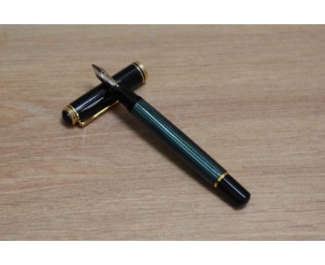 A Pelikan M600 piston fill fountain pen in green striped with black cap having Pelikan 18C 750 BB nib