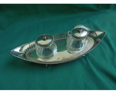 Ink stand containing 2 glass ink wells with silver tops on pierced base, Chester 1907