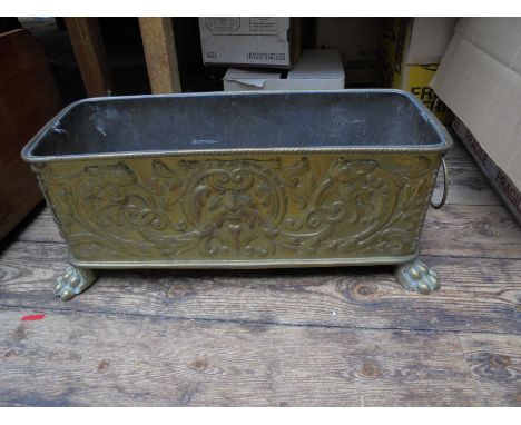 Sizeable brass planter with lion head handles and paw feet with original lead liner