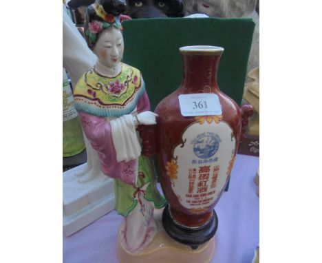 Unusual ceramic item of a Chinese Lady with large vessel to side on stand stating 'Tsui Weng Ting Brand Kaoliang Hung Chiew T