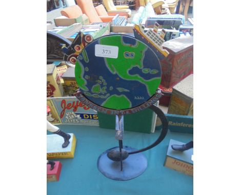 Unusual item of metal weighted balancing advertising sign being The World rotating having moving car and ship and words stati