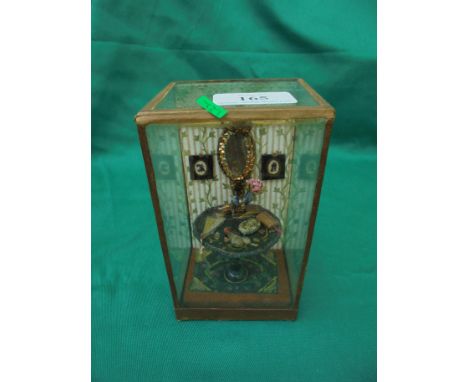 Delightful small model of a Victorian room containing table with various items, wall mirror, silhouettes and wall paper all w