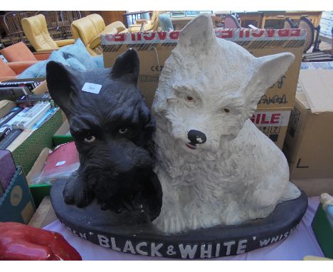 Extremely large Black and White Scotch whisky advertising with black and white logo dogs in plasterwork, (over 24" wide and 2