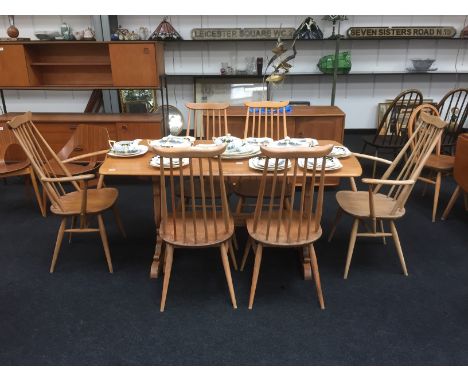 An Ercol Windsor light finish refectory table in elm and beech together with six matching spindle back Quaker dining chairs.