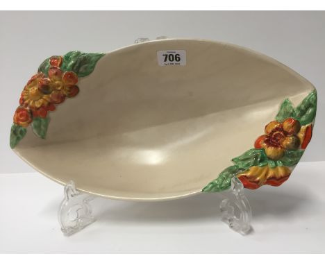 A Clarice Cliff Wilkinson Pottery elongated fruit bowl, decorated in an embossed floral design in tones of orange, yellow and