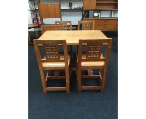 Robert Thompson Mouseman: A small light oak refectory table with Adzed top (70cm x 107cm) together with four matching open la