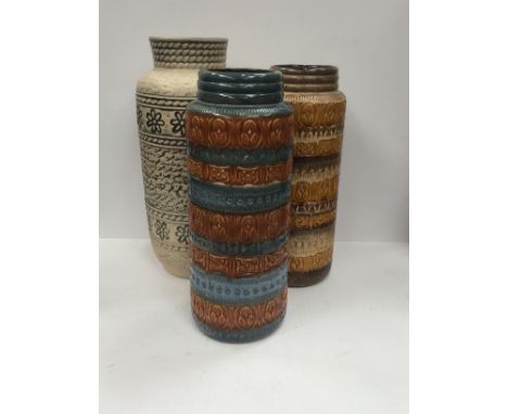 Three various mid 20th century West German Art Pottery stick stands decorated in various molded designs.