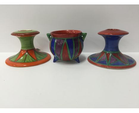 Two Clarice Cliff Bizarre Newport Pottery squat candlesticks, decorated in Geometric patterns (one af) together with a Cauldr