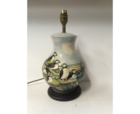 A Moorcroft Pottery lamp base decorated in the Puffins design with wired fittings and shade (26cm) 