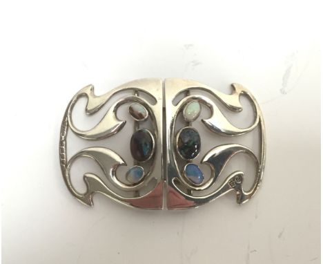 A Murrle Bennett & Co. silver and opal set belt buckle. CONDITION REPORT: Small graze to black opal to one of the centre ston