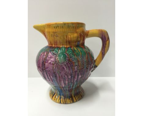 A Clarice Cliff Delecia drip glazed jug with embossed flower decoration to sides and all-over drip glaze effect, printed Dele
