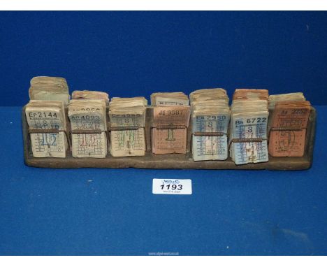 A vintage 1950's London Transport Bus conductor's Ticket holder with used tickets, 11 1/4" x 2 3/4" x 1 1/2".
