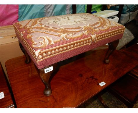 A rectangular tapestry upholstered seated Stool standing on cabriole legs, 14 5/8'' x 22 1/4" x 12'' high.
