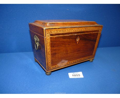 A Mahogany tea Caddy with marquetry chevron stringing standing on ball feet, 7 1/2" wide x 4 1/2" deep x 5 1/2" high.