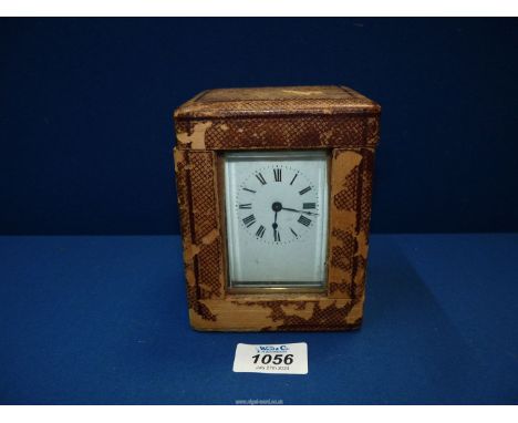 A brass Carriage clock with Roman numerals and bevelled glass, with leather travelling case and key.