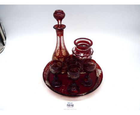 A Ruby and clear etched glass decanter on tray with four glasses and a similar pot, a large crack and repair on tray.