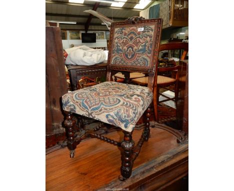 An elegant Oak framed side Chair having carved detail to the frame of the backrest, standing on turned legs and an "H" stretc