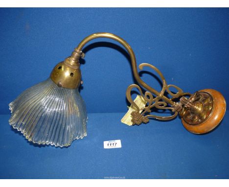 An Art Nouveau brass wall light with glass shade in pleated design.