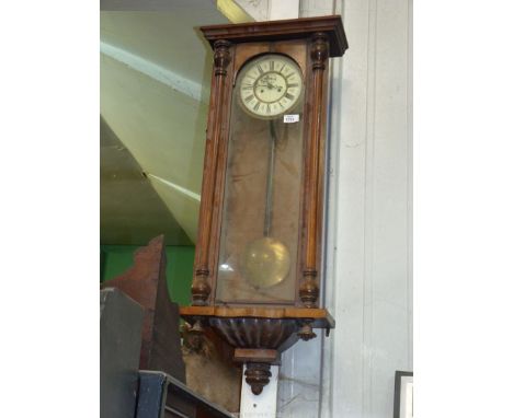 A Vienna wall Clock, Mahogany and pine cased, with ceramic dial with Roman numerals, weights present, etc. (in need of some r