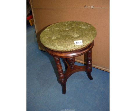 An Edwardian Mahogany framed Piano Stool standing on three turned legs with splay feet, adjustable for hegiht from 18 5/8'' t