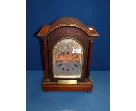 A Mahogany cased Bracket/Mantle Clock with arched, silvered face having Roman numerals, silent/chime selector, strikes on bar