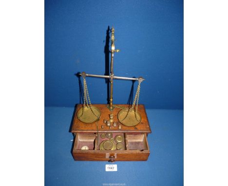 A chemist's Scales with weights in drawer below, cord broken, by Doyle & Son, London.
