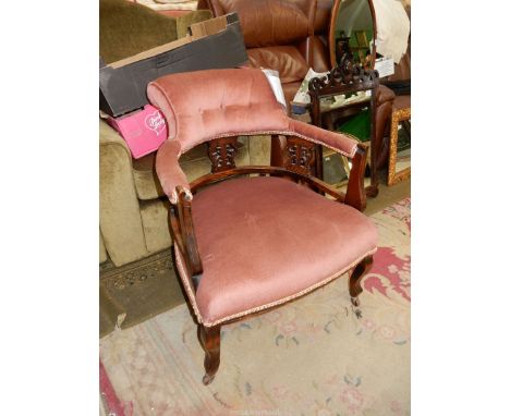 A likely Edwardian Mahogany framed open armed Elbow Chair, the seat back and arms upholstered in pink Dralon and standing on 