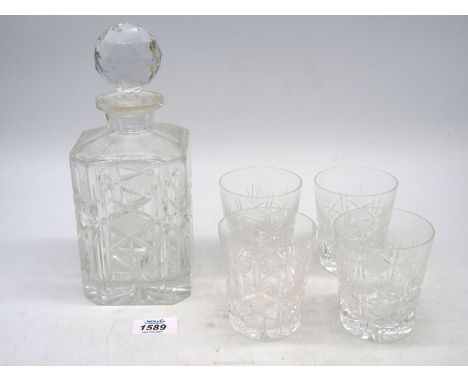 A glass decanter with four matching whisky tumblers.