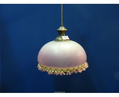 A pink glass light fitting with tasseled edging.
